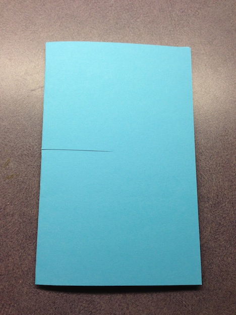 Start by folding a 8" x 11" sheet of card stock in half. Cut a slit in the centre, through the folded edge