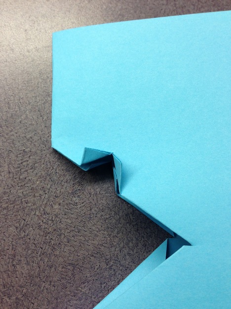 Fold the corners out - in the same manner as Step 2. It will be tricky if the paper is thick. Use a ruler to score the edges.